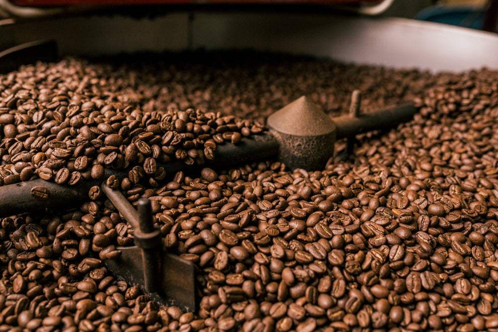 Freshly roasted coffee beans turning in a small-batch roaster